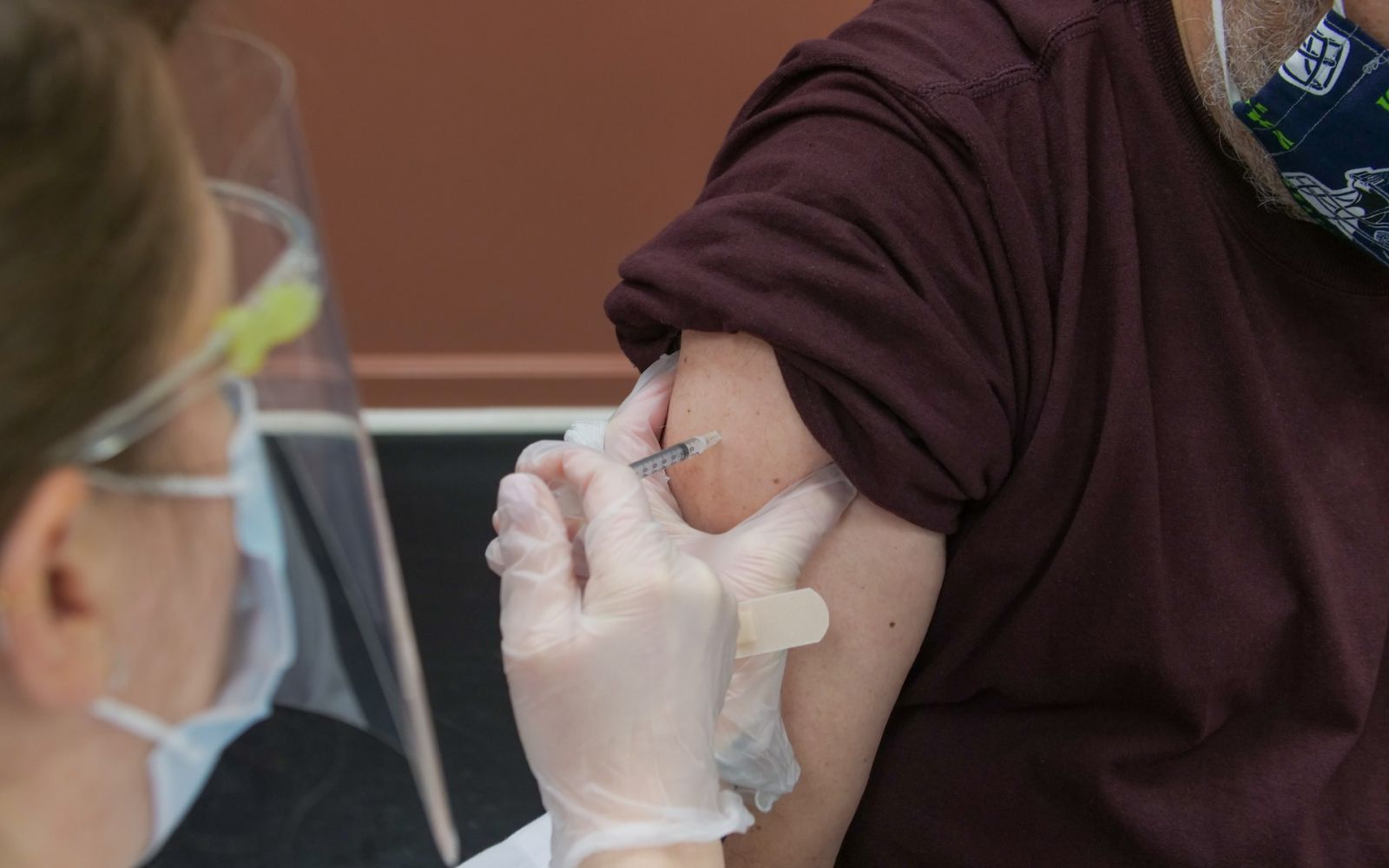 nurse administering a shot to shoulder
