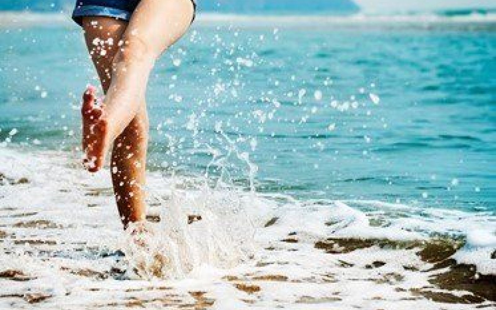 woman walking in the surf