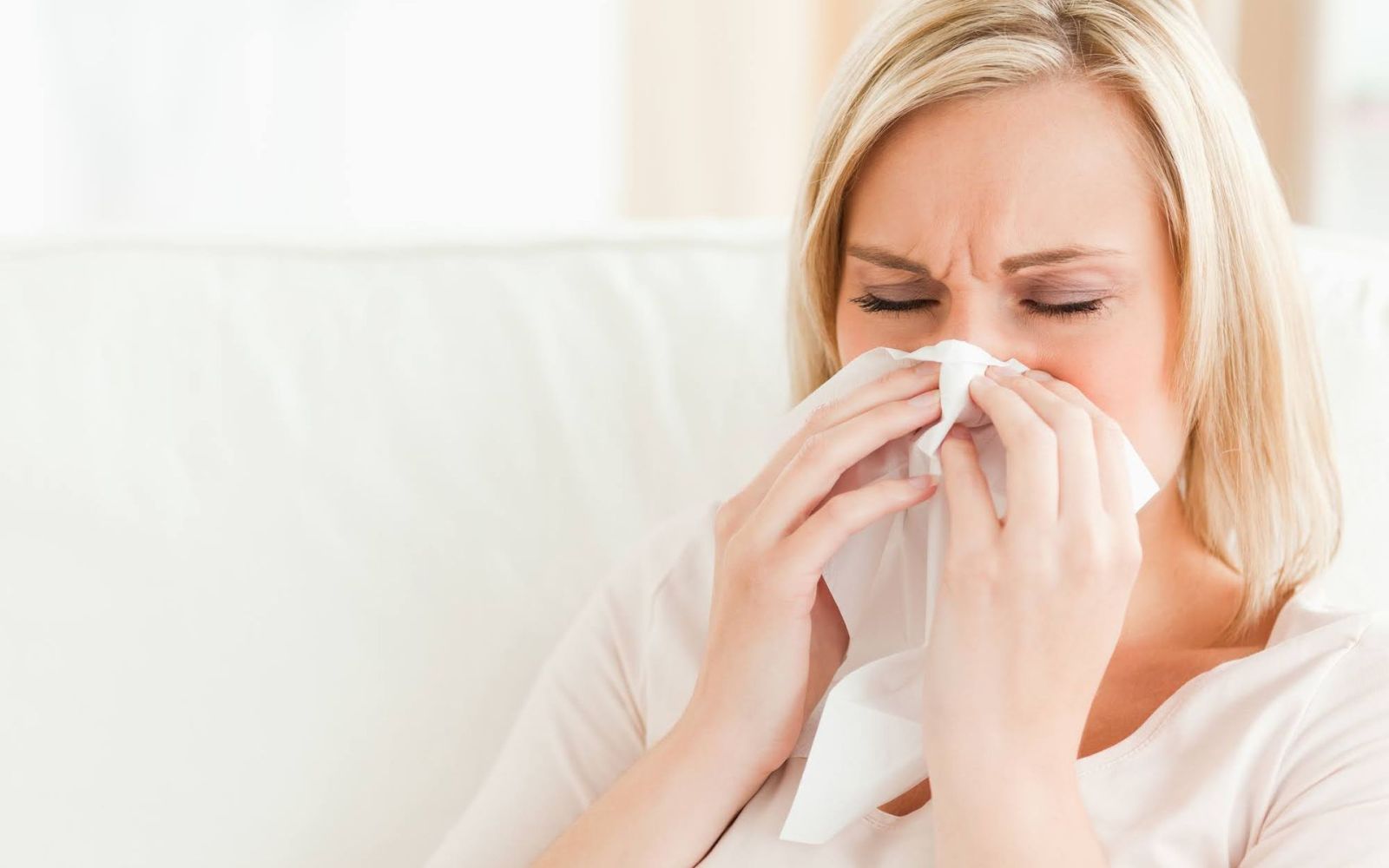 woman sneezing
