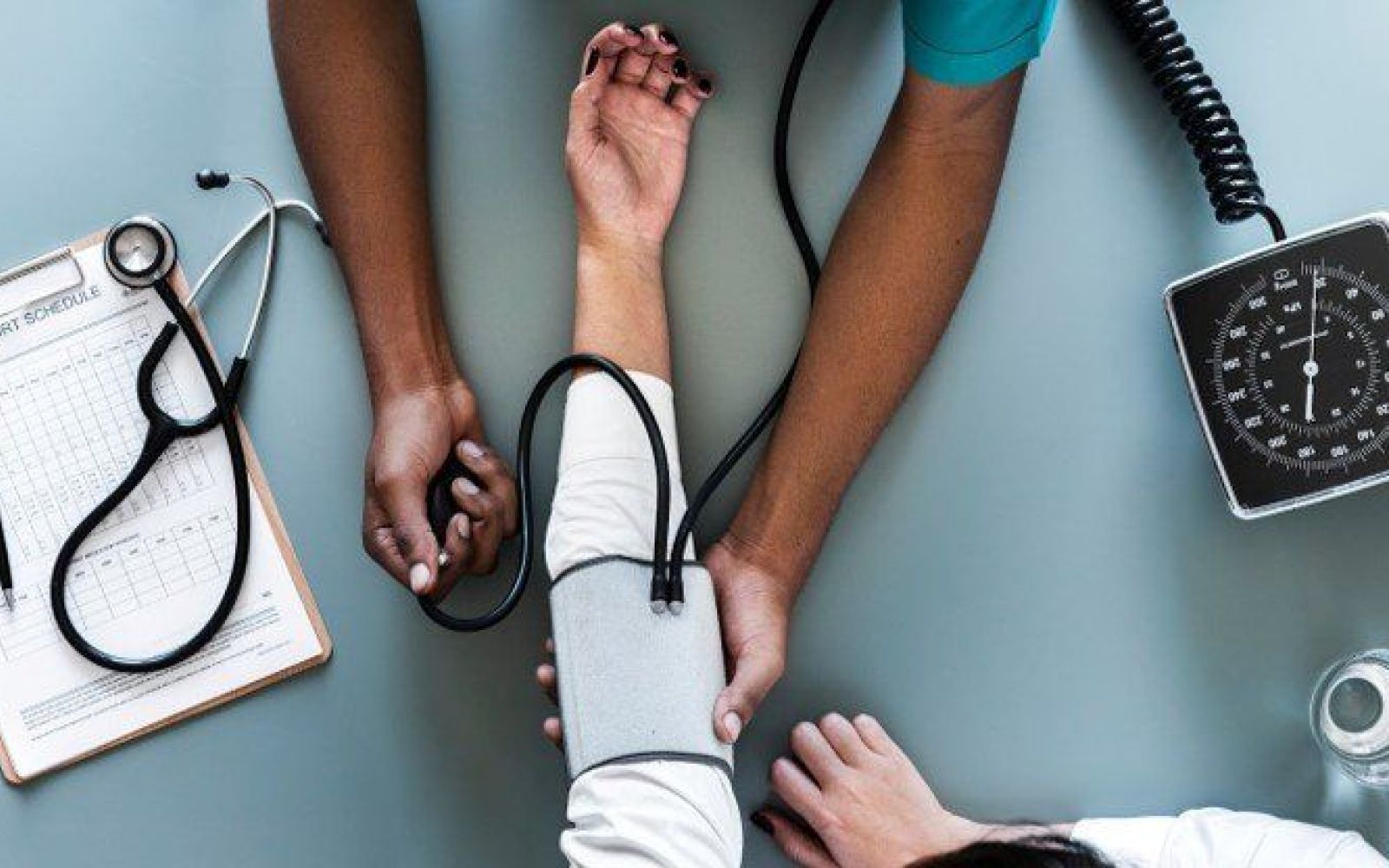 nurse taking patient blood pressure