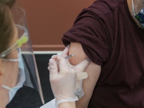 nurse administering a shot to shoulder