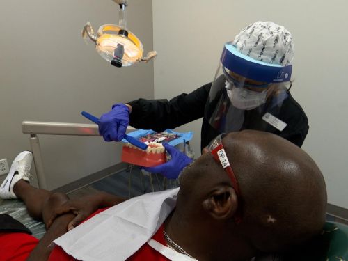 Dentist assisting patient at Nashville General