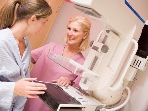 nurse prepping woman for mammogram