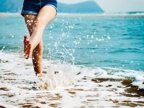 woman walking in the surf