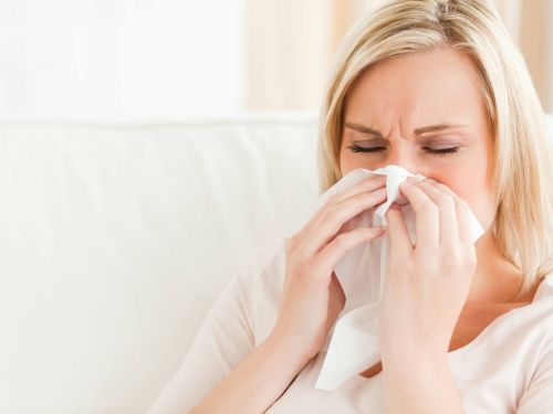 woman sneezing