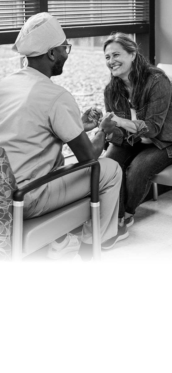 Nurse and patient holding hands