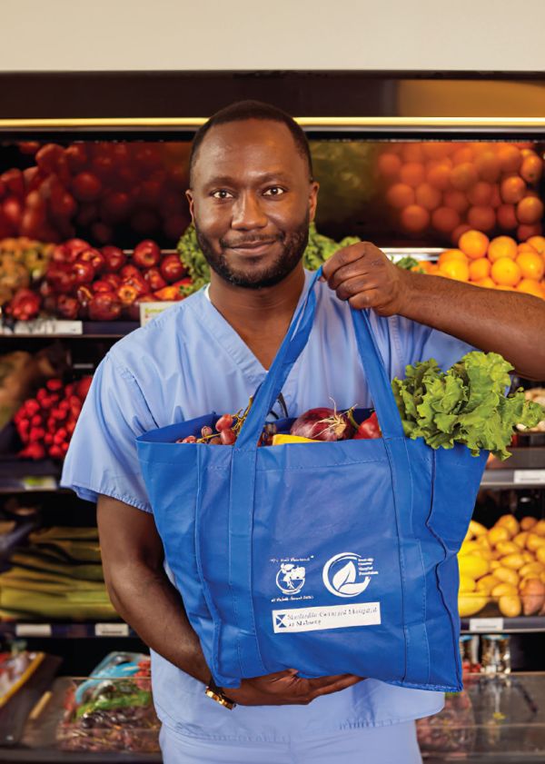 NGH staff holding a food tote in the food pharmacy