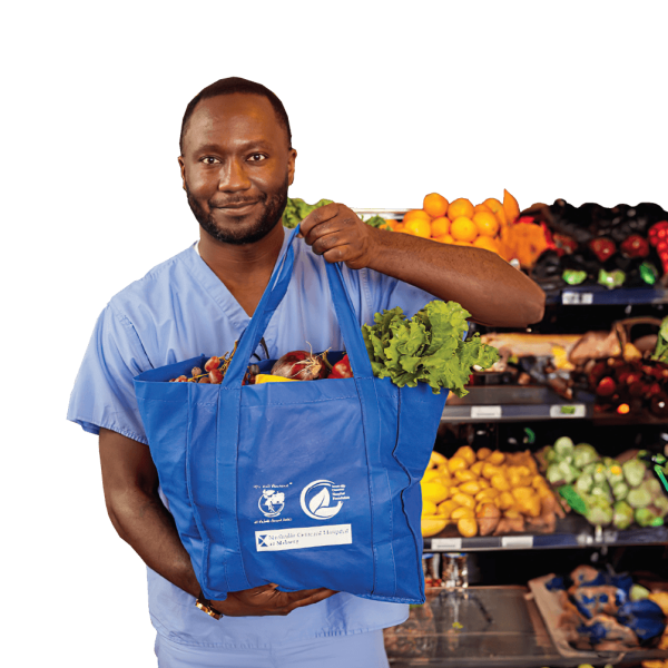 image of staff with bag of food from the Food Pharmacy