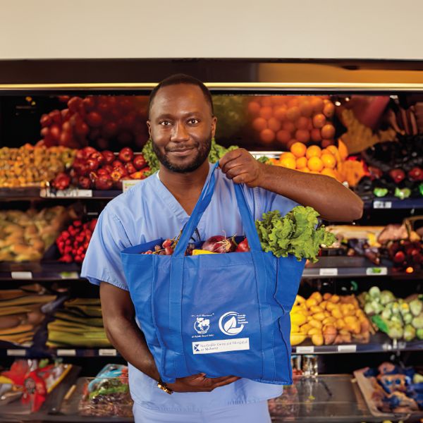 man holding food tote in the Food Pharmacy program: