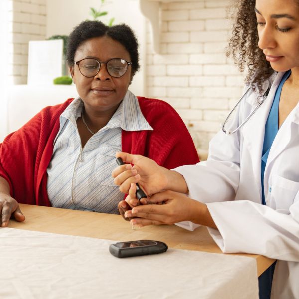 nurse helping elderly lady with insulin injection