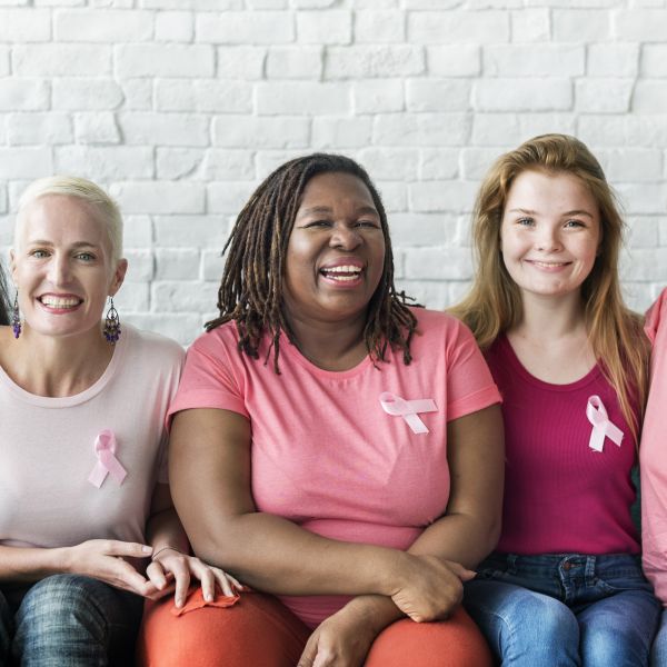 Women wearing breast cancer awareness ribbons