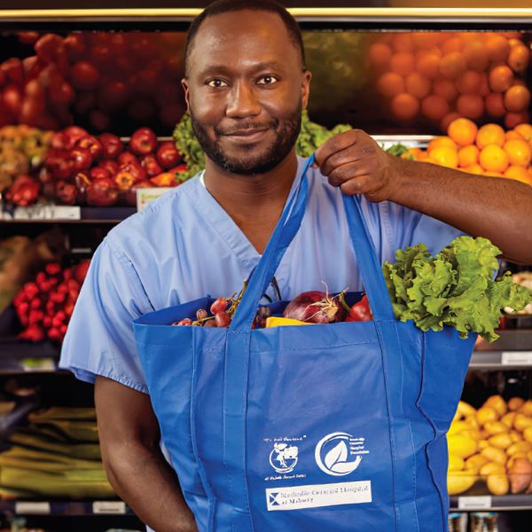 NGH staff holding a food tote in the food pharmacy