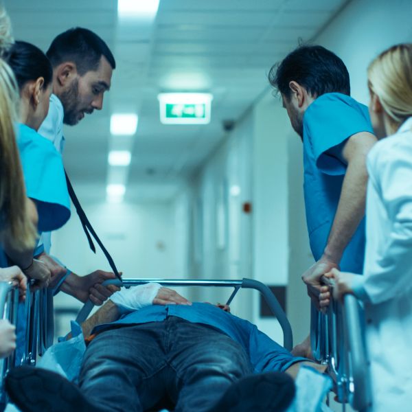 image of hospital staff wheeling trauma patient