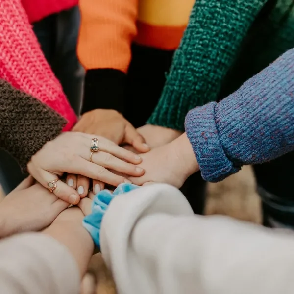 large group joining hands in a circle