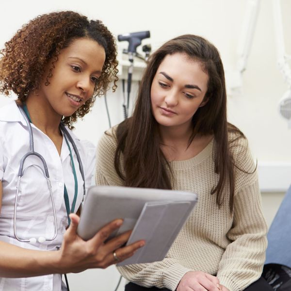 Nurse reviewing results with a patient on a tablet