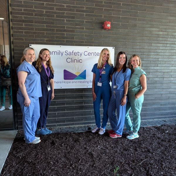 GH original photography. Medical forensic team in scrubs in front of the Family Safety Center Clinic sign.