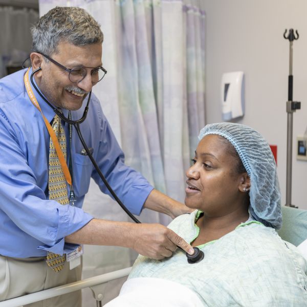 Doctor examining patient with stethoscope